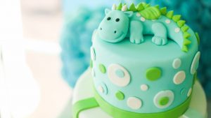 Green cake with a dinosaur on it