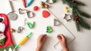 Festive christmas playdough shapes being made by a preschooler