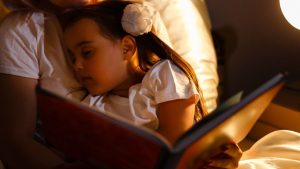 Girl falling asleep while being read a story