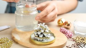  A winter craft DIY snowglobe being made out of a jar and an ornament