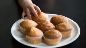 toddler reaching out for banana muffins